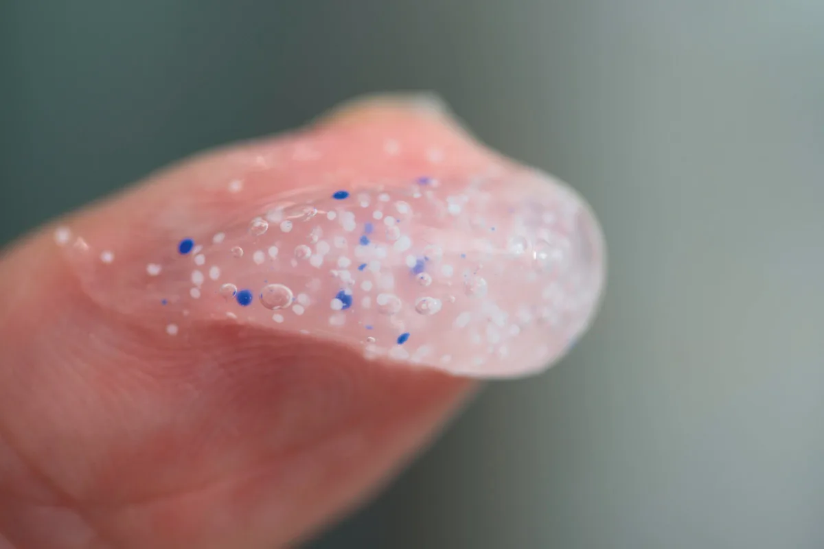 17-worst-ideas-21st-century-microbeads Close-up of microbeads in a clear gel on the tip of a person's finger.
