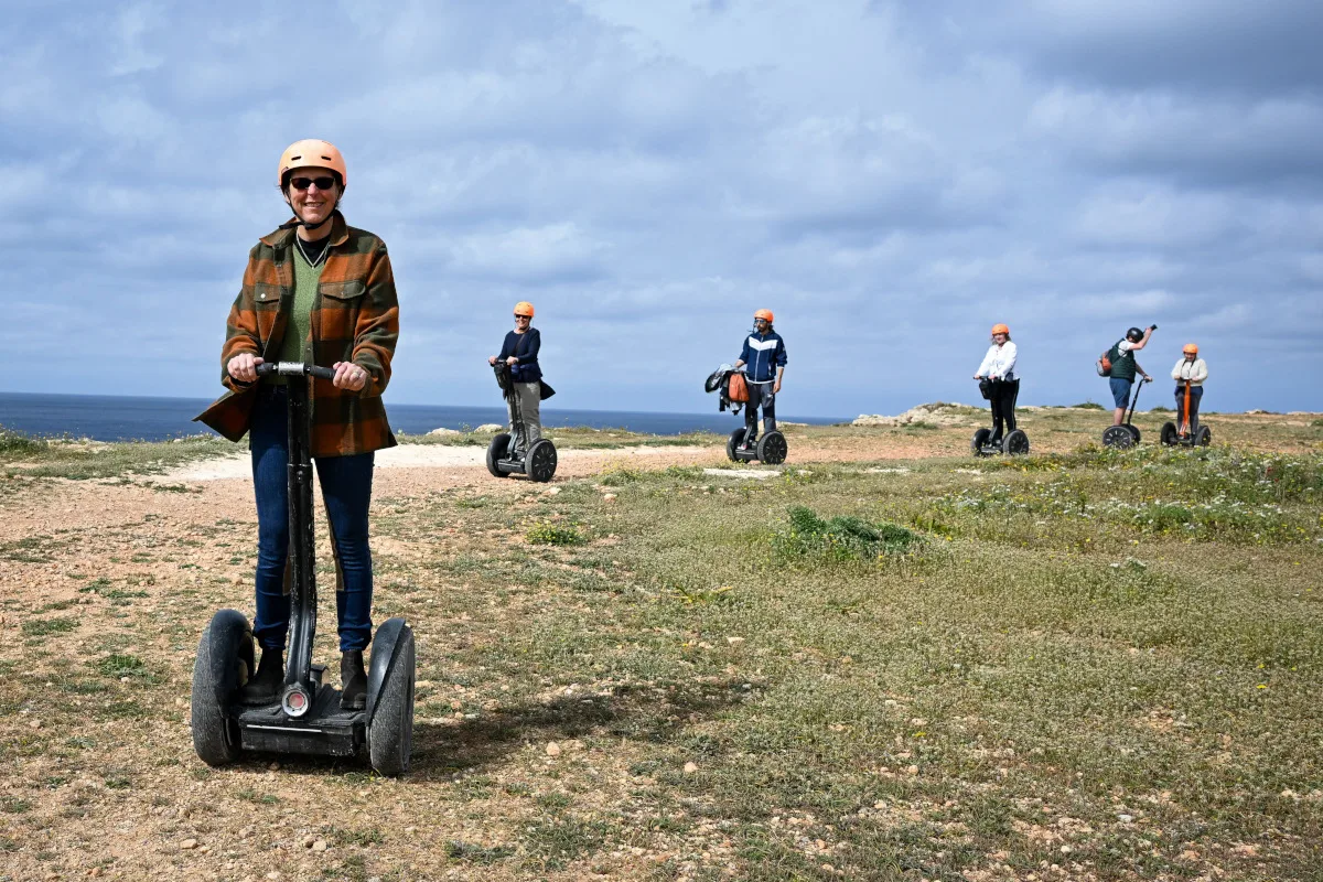 17-worst-ideas-21st-century-segway A group of people riding Segways on a clifftop path.