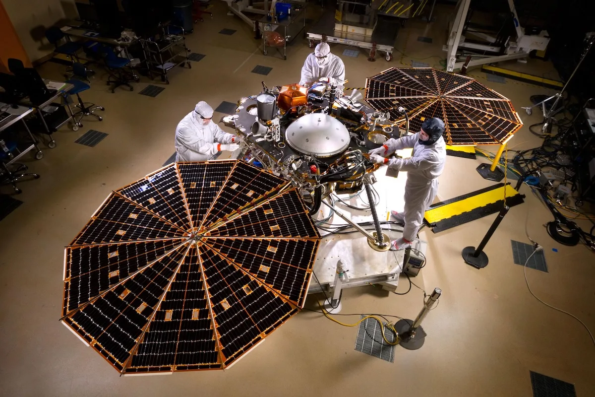 pia19664-marsinsightlander-assembly-20150430 Three scientists in white overalls prepare the NASA InSight Lander in a clean room